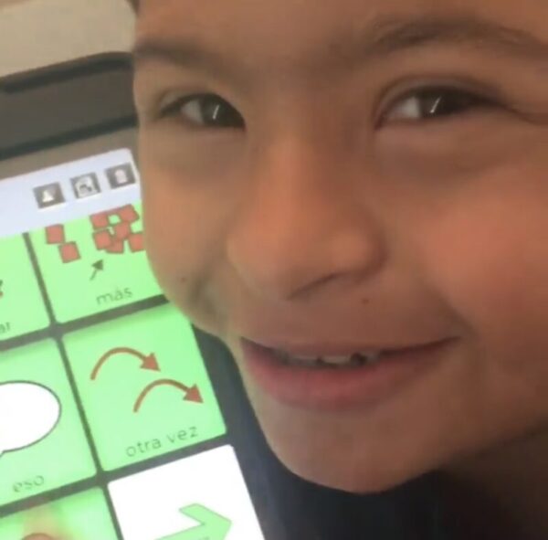Child using BRIDGE Communication app on ipad with Spanish vocabulary.